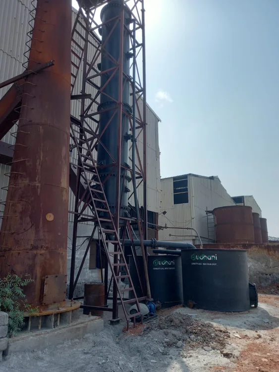 Tall outdoor plant equipment, steel supports and tanks beside the factory
