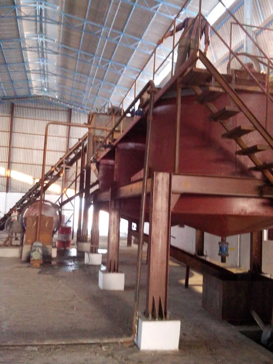 Raised processing equipment and a conveyor inside the manufacturing hall