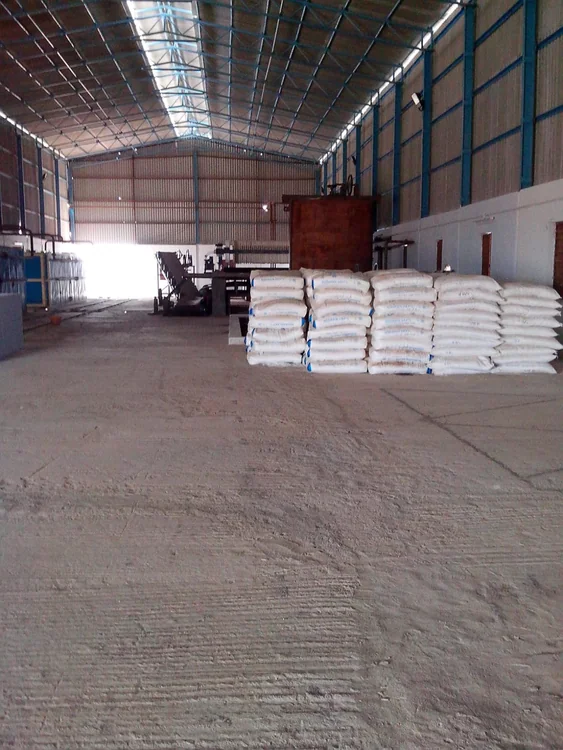 Stacks of filled bags in a factory storage area