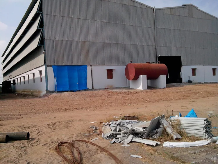 The factory building exterior and an outdoor horizontal tank