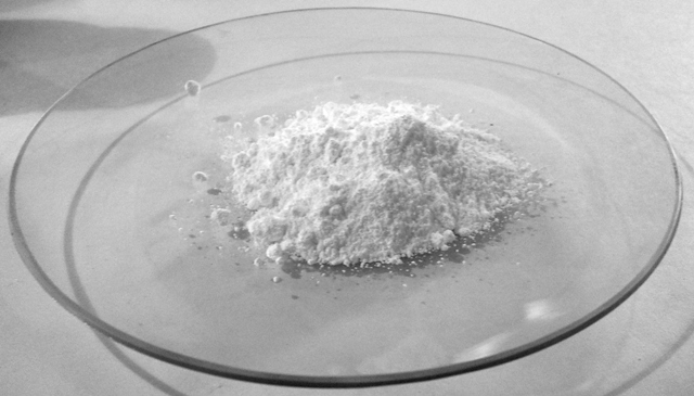 Real barium carbonate powder on a clear laboratory watch glass