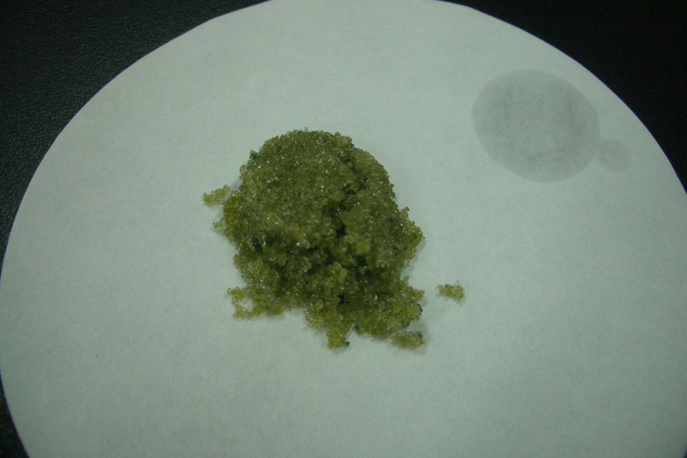 A photographed sodium sulphide sample on a white dish